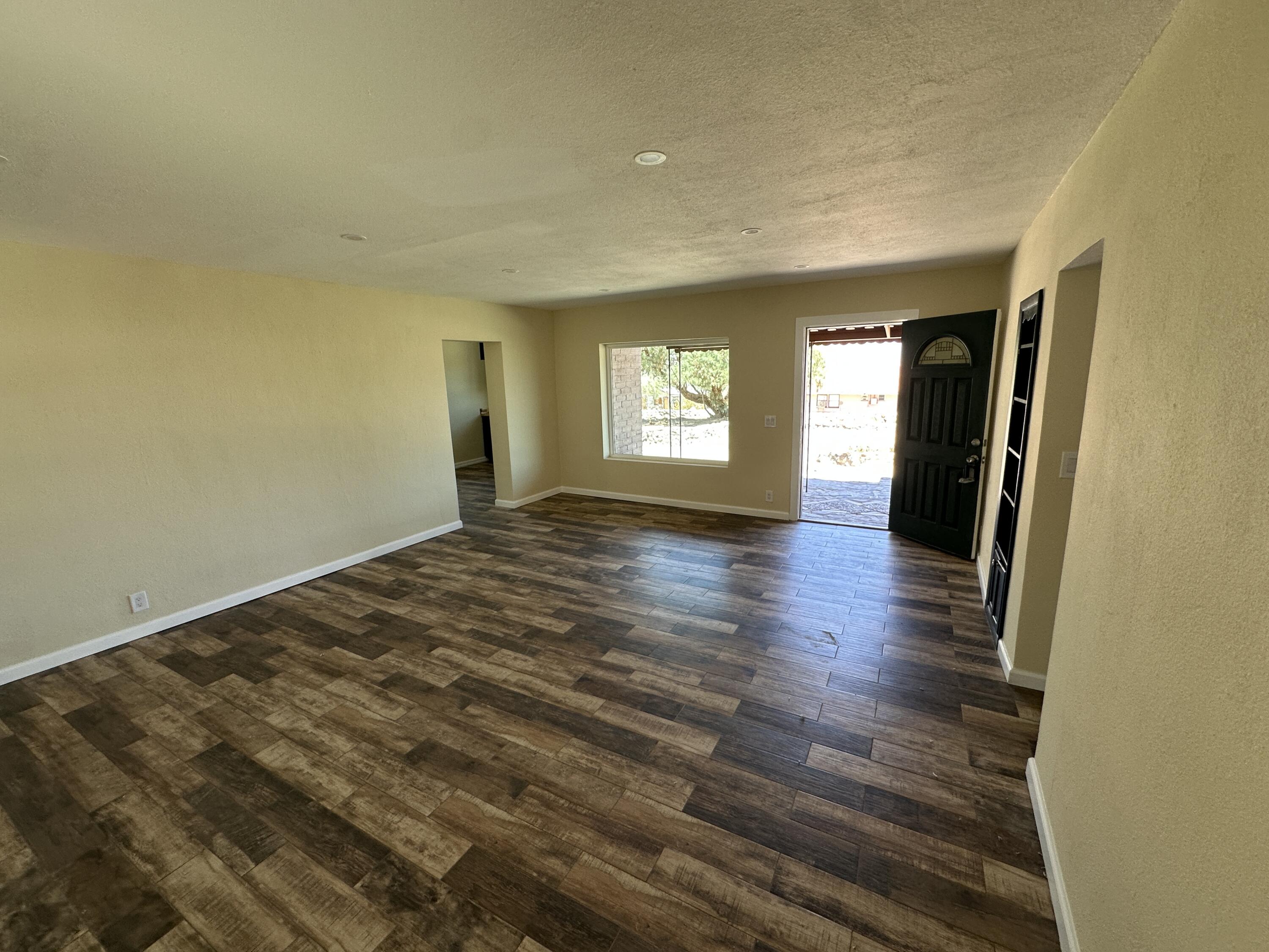 12164 B Street Trona, CA 93562 - Photo 6 of 41 a view of an empty room with window and wooden floor