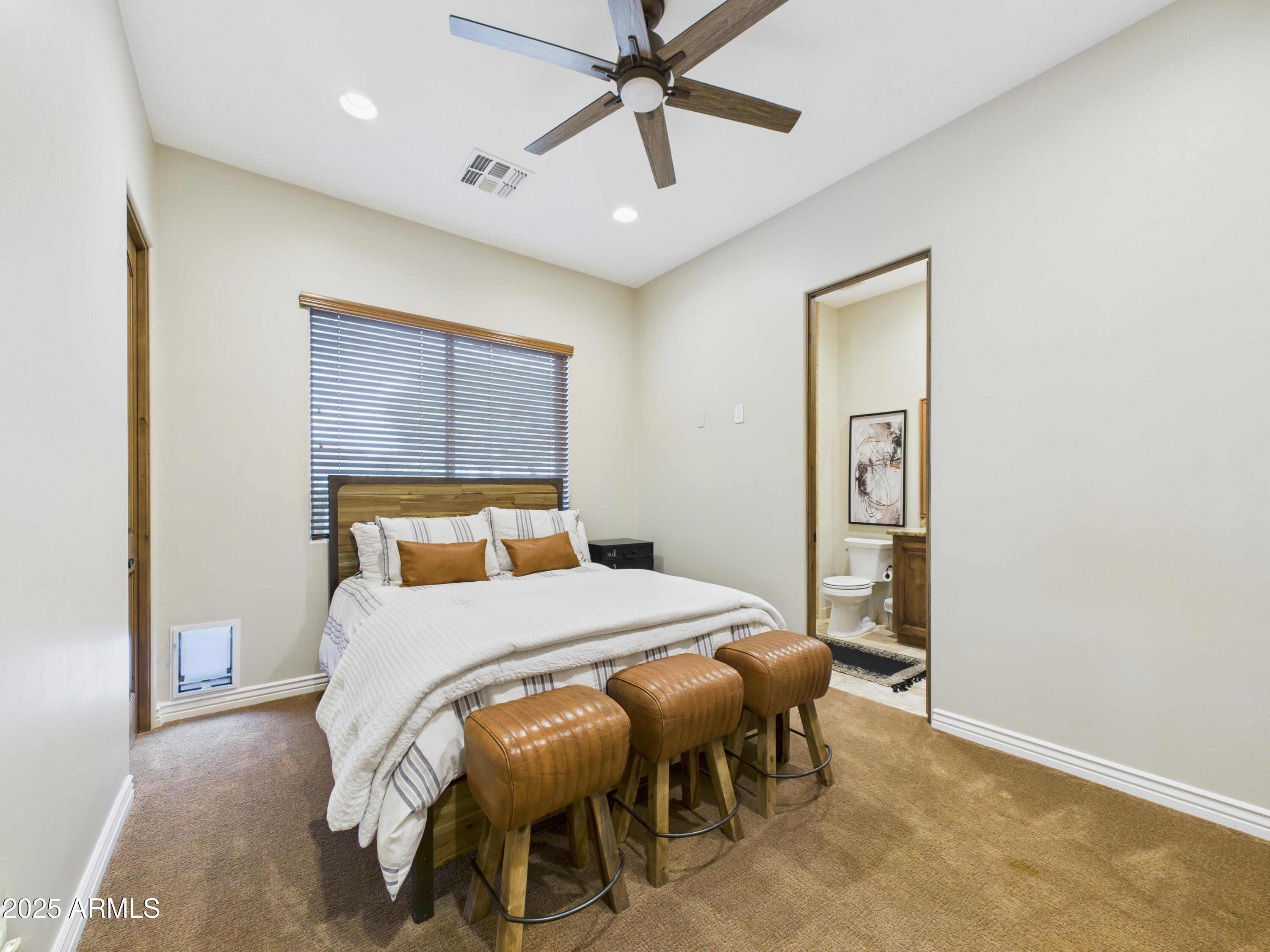 806 West Desert Ranch Road Phoenix, AZ 85086 - Photo 22 of 36 a bedroom with a bed and a table