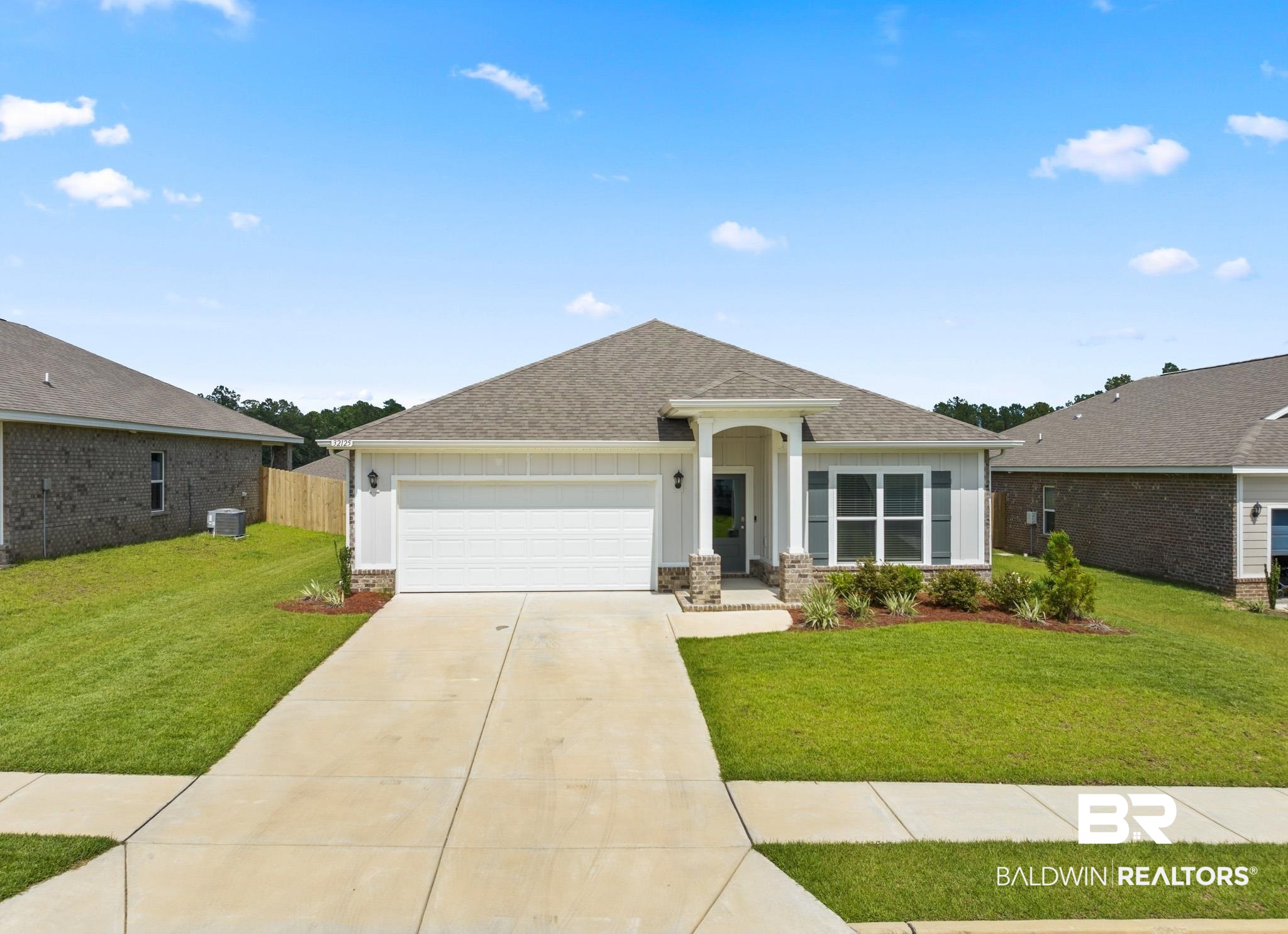 32125 Lyon Road Daphne, AL 36527 - Photo 3 of 70 Single-story residence featuring a two-car garage, stone accents, and a covered entryway