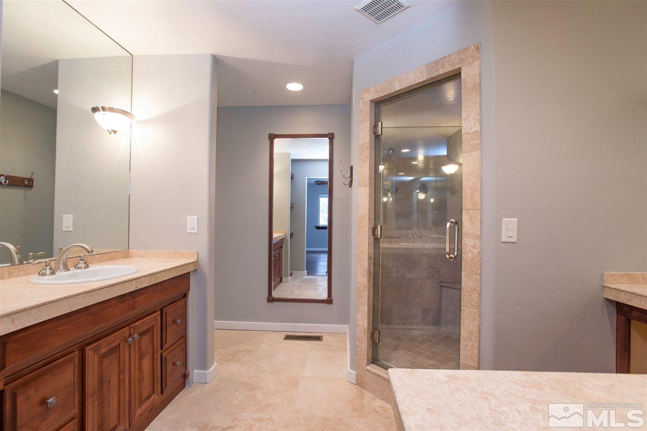 985 Akard Drive Reno, NV 89503 - Photo 14 of 25 a bathroom with a mirror sink and shower