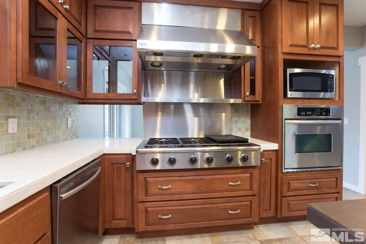 985 Akard Drive Reno, NV 89503 - Photo 8 of 25 a stove top oven sitting inside of a kitchen