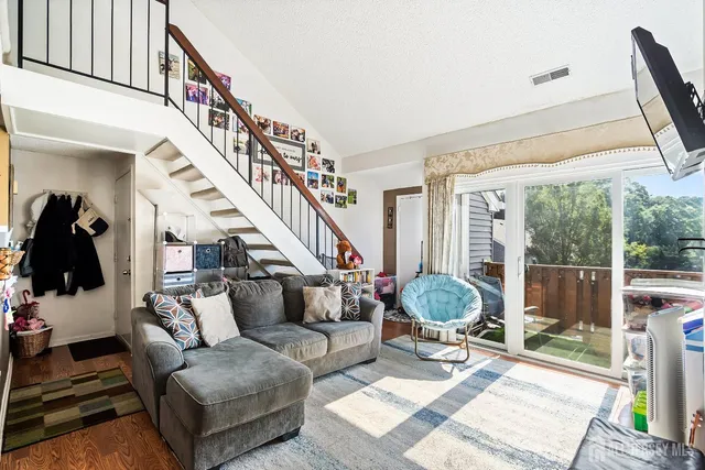 a living room with furniture and a chandelier