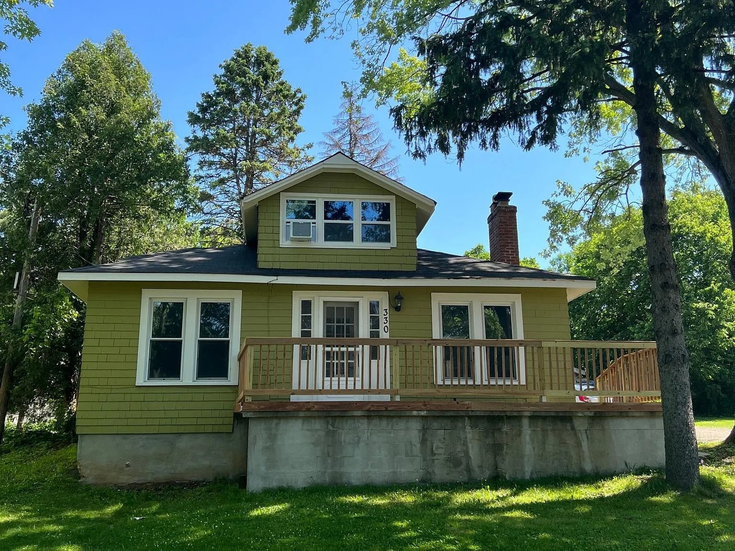 330 Park Avenue Cary, IL 60013 - Photo 1 of 13 a front view of a house with a garden