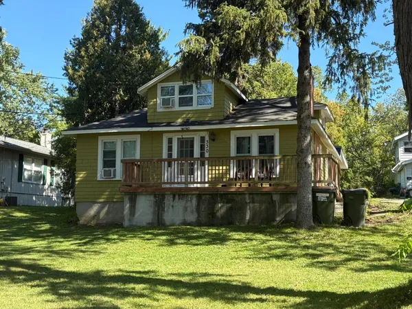 a front view of a house with a yard table and chairs