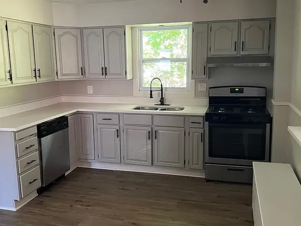 a kitchen with a sink stove and cabinets