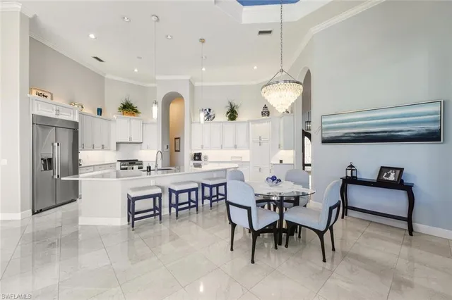 a large kitchen with a table and chairs