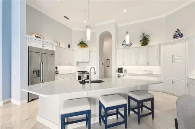 a kitchen with a dining table chairs and white cabinets