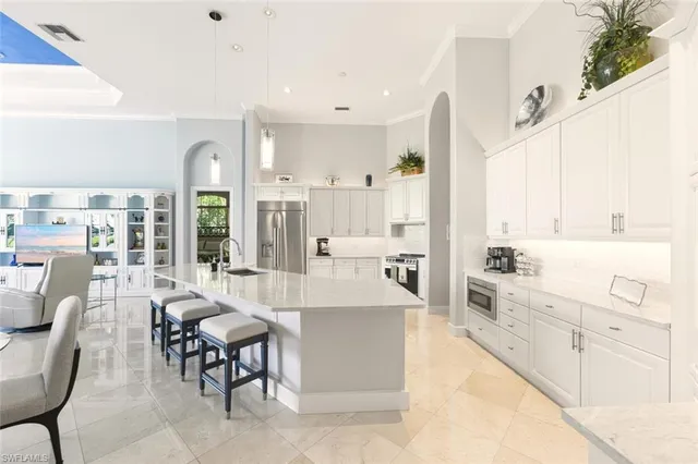 a large white kitchen with cabinets