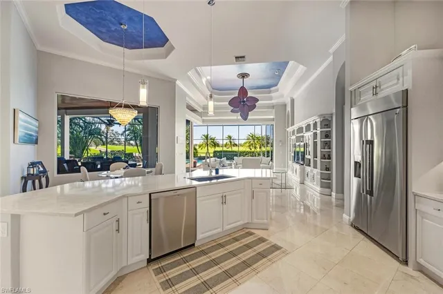 a large white kitchen with a large window