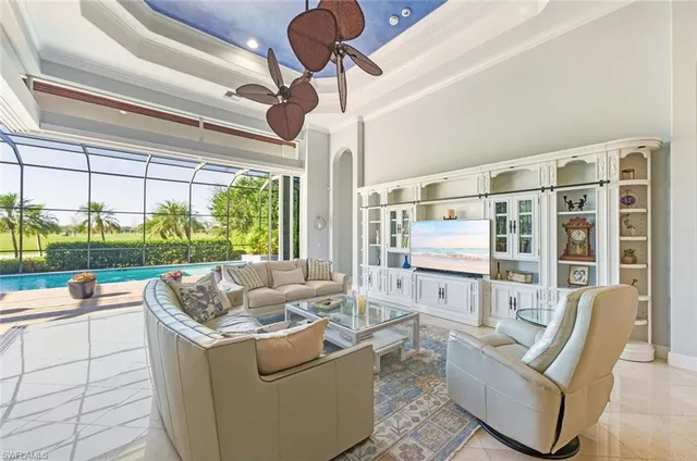 a living room with furniture and a floor to ceiling window