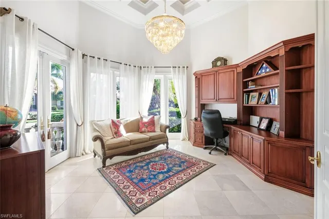 a living room with furniture a bookshelf and a window