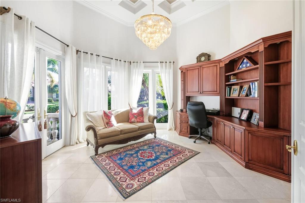 396 Terracina Way Naples, FL 34119 - Photo 27 of 50 Office space featuring built in study area, a high ceiling, a chandelier, ornamental molding, and light tile patterned flooring