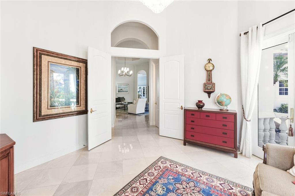 396 Terracina Way Naples, FL 34119 - Photo 28 of 50 Sitting room featuring a chandelier and a high ceiling