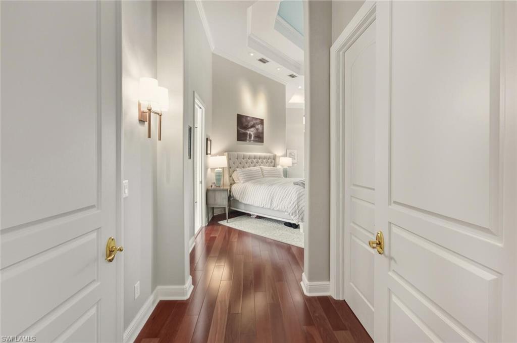 396 Terracina Way Naples, FL 34119 - Photo 29 of 50 Corridor with ornamental molding and dark wood-style floors