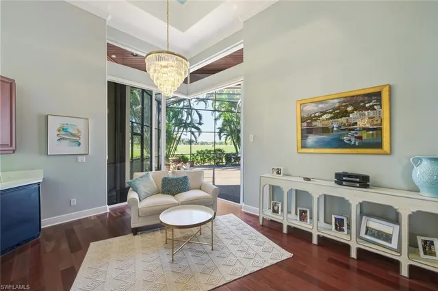 a living room with furniture a window and a chandelier