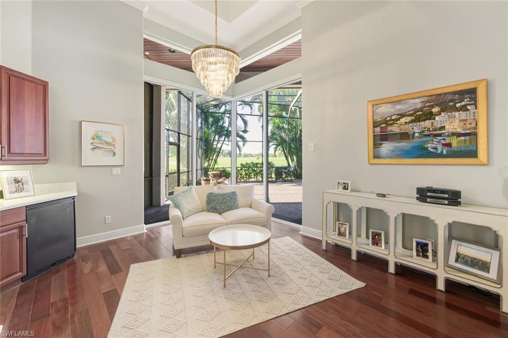 396 Terracina Way Naples, FL 34119 - Photo 33 of 50 Sitting room with dark wood-style floors and a chandelier