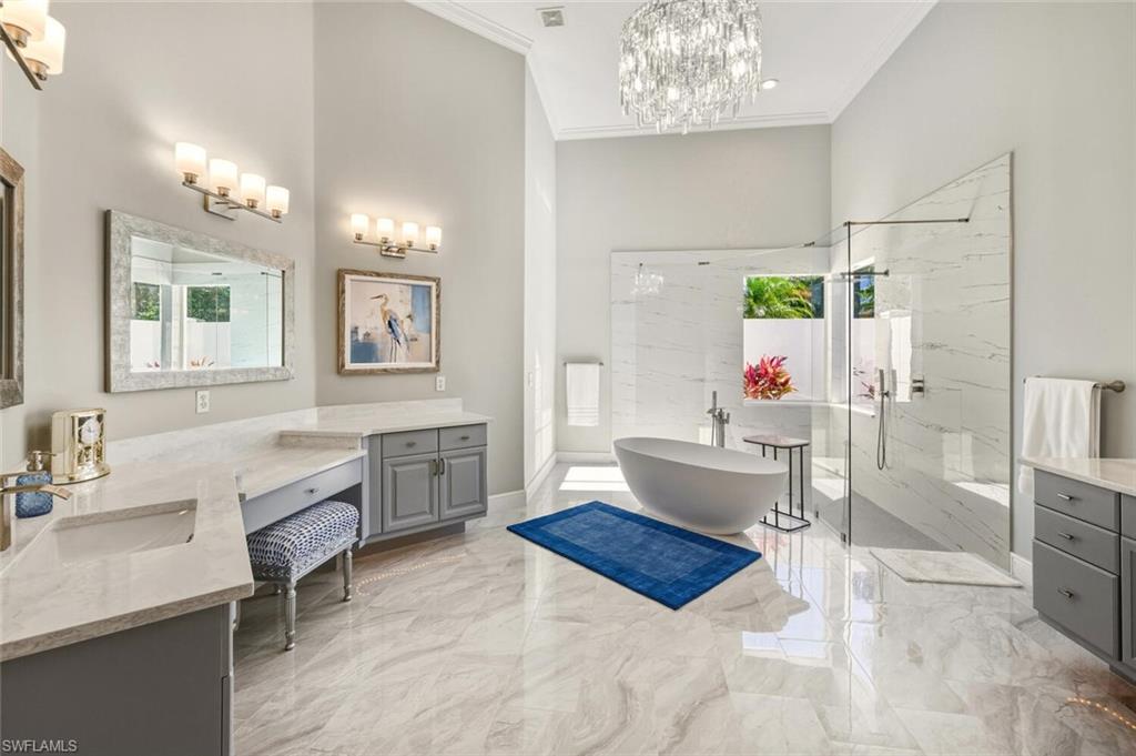 396 Terracina Way Naples, FL 34119 - Photo 37 of 50 Full bath with vanity, a marble finish shower, a soaking tub, light marble finish flooring, and ornamental molding
