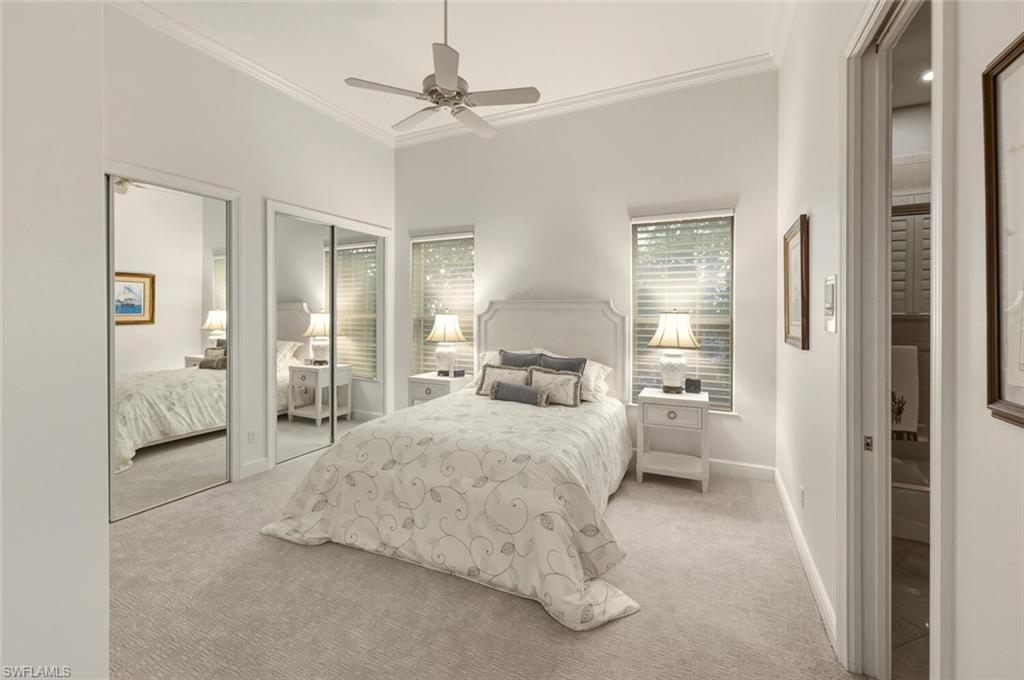 396 Terracina Way Naples, FL 34119 - Photo 39 of 50 Bedroom featuring light carpet, multiple closets, crown molding, and ceiling fan