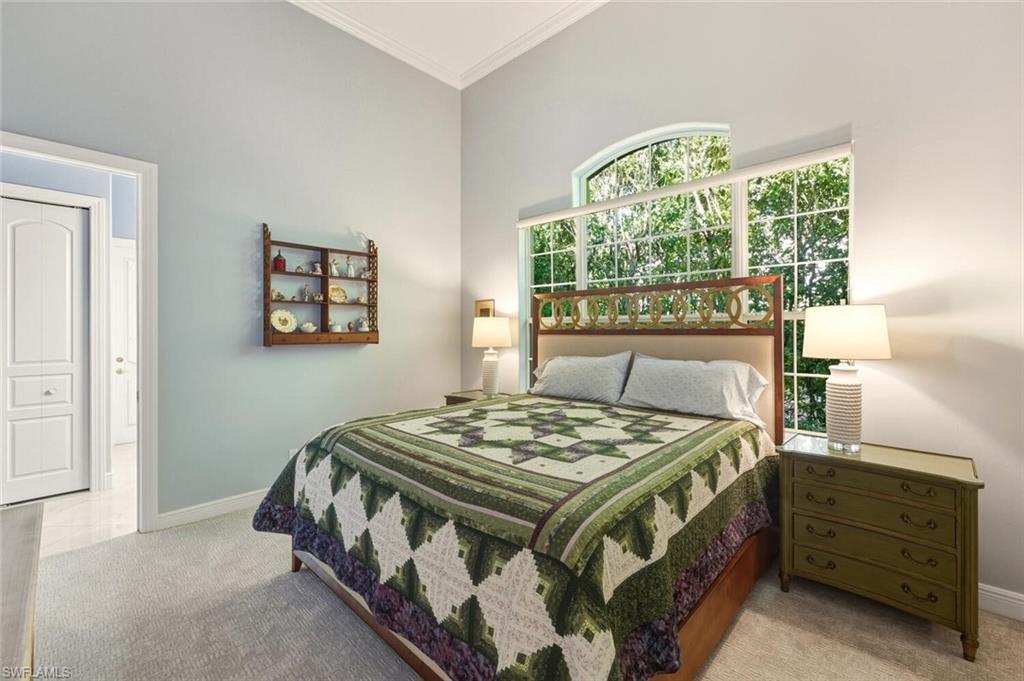 396 Terracina Way Naples, FL 34119 - Photo 45 of 50 Bedroom featuring crown molding and light colored carpet