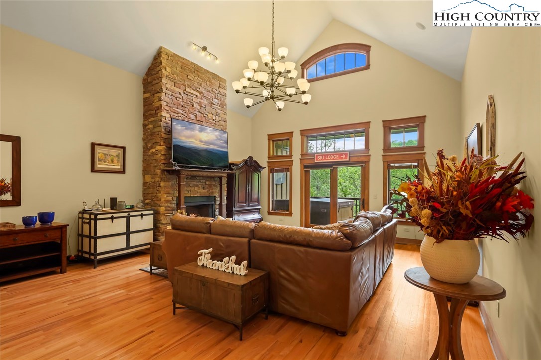 138 South Camp Road, Unit 103 Boone, NC 28607 - Photo 15 of 50 a living room with furniture chandelier and a fireplace