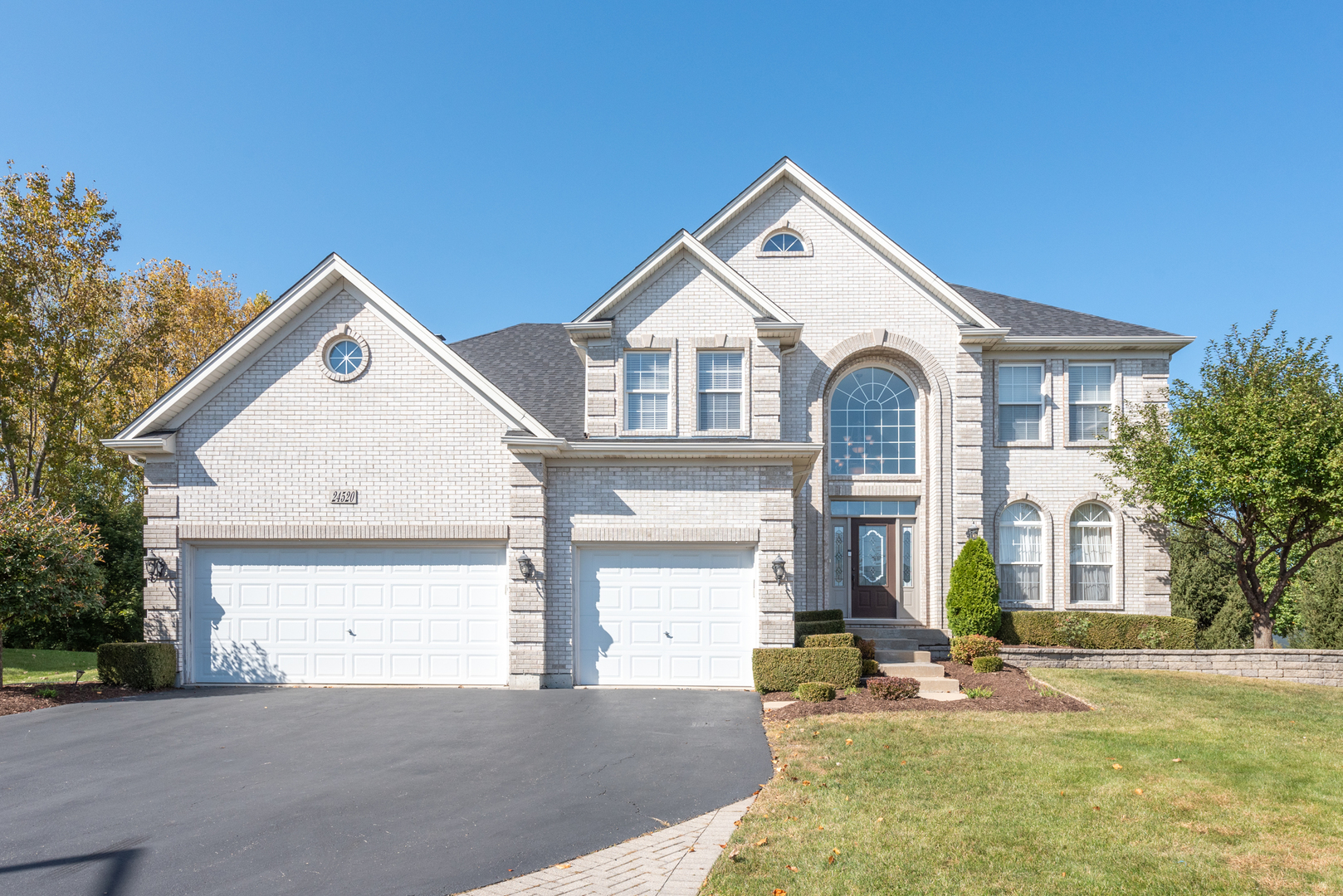 24520 Rockefeller Court Plainfield, IL 60544 - Photo 1 of 57 a front view of a house with a yard
