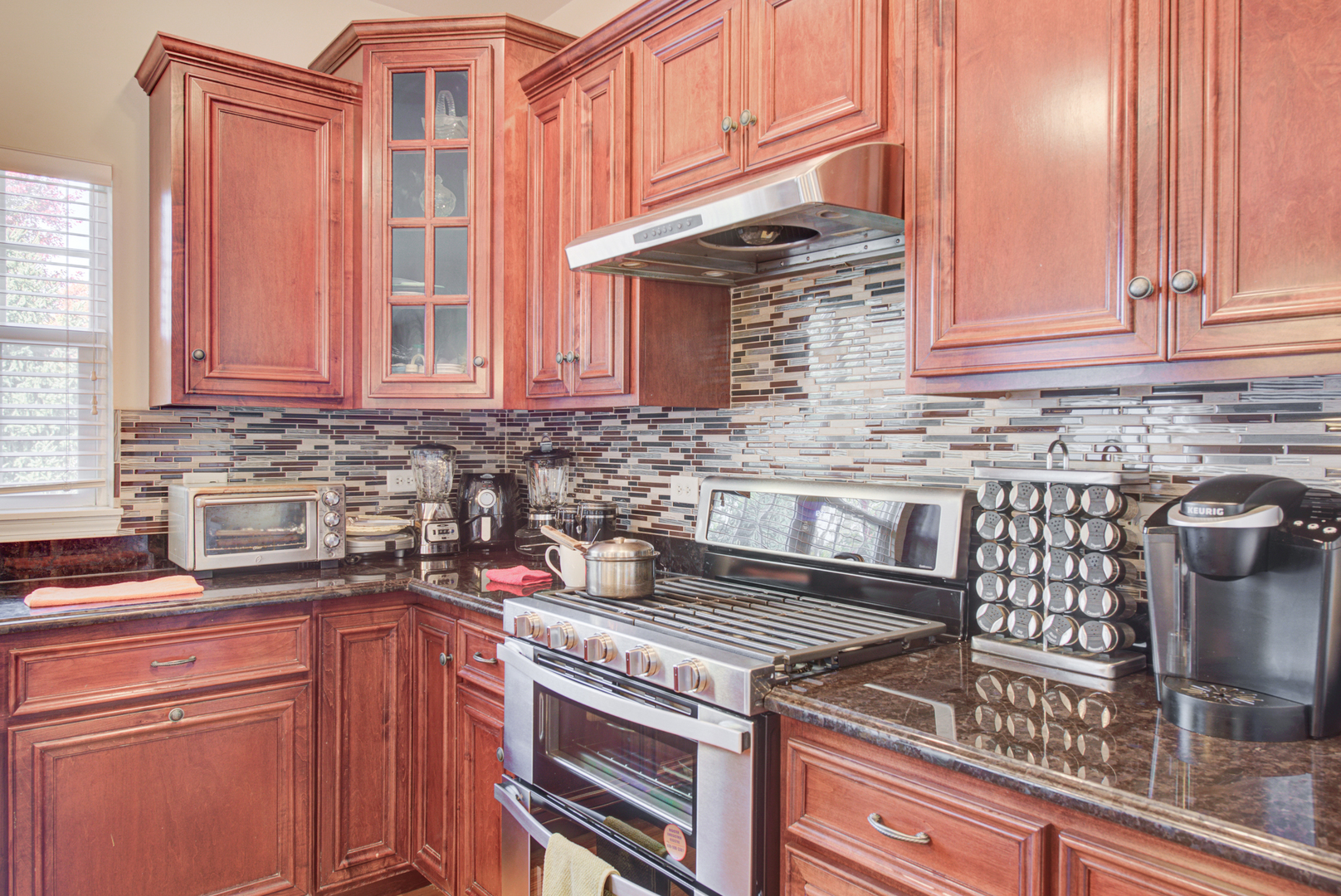 24520 Rockefeller Court Plainfield, IL 60544 - Photo 14 of 57 a kitchen with stainless steel appliances granite countertop a stove a sink and a microwave