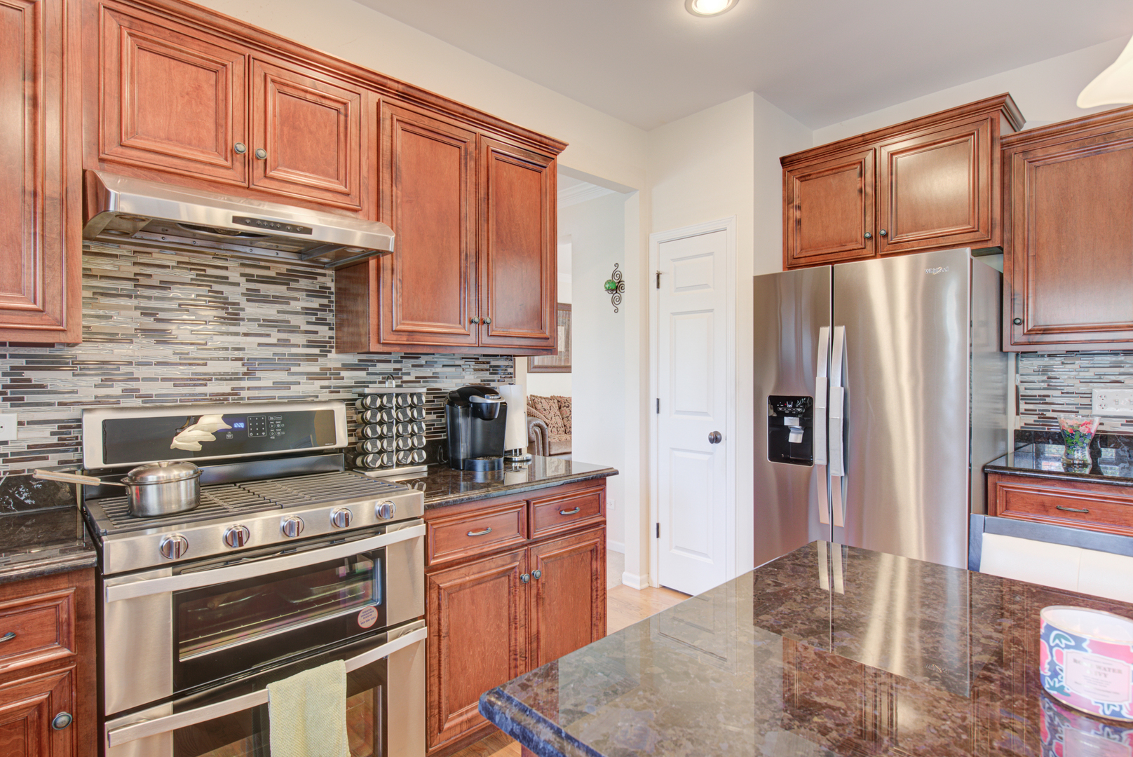 24520 Rockefeller Court Plainfield, IL 60544 - Photo 15 of 57 a kitchen with stainless steel appliances granite countertop a refrigerator stove and sink
