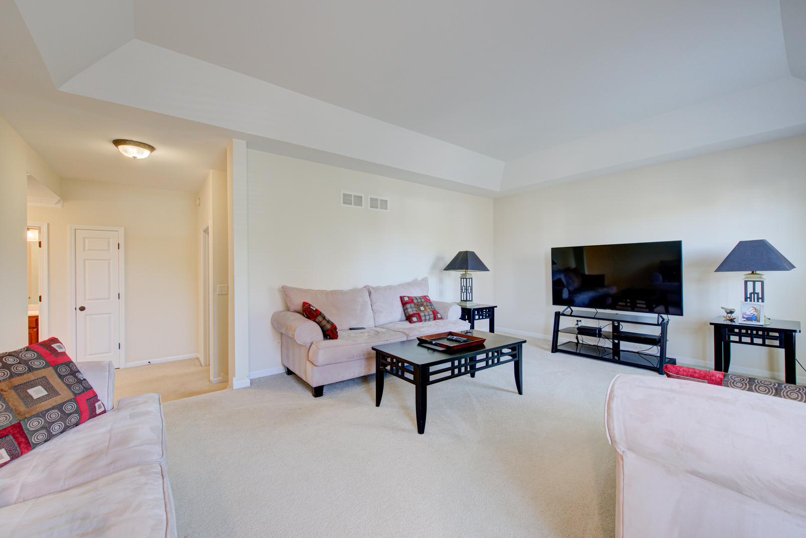 24520 Rockefeller Court Plainfield, IL 60544 - Photo 19 of 57 a living room with furniture and a flat screen tv
