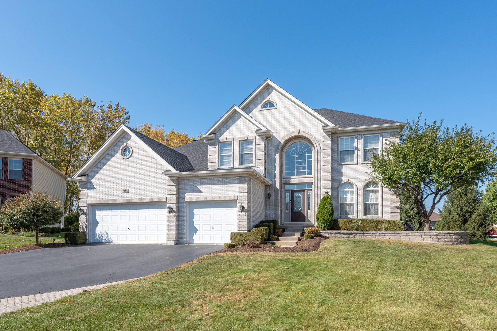 24520 Rockefeller Court Plainfield, IL 60544 - Photo 2 of 57 a front view of a house with yard and green space