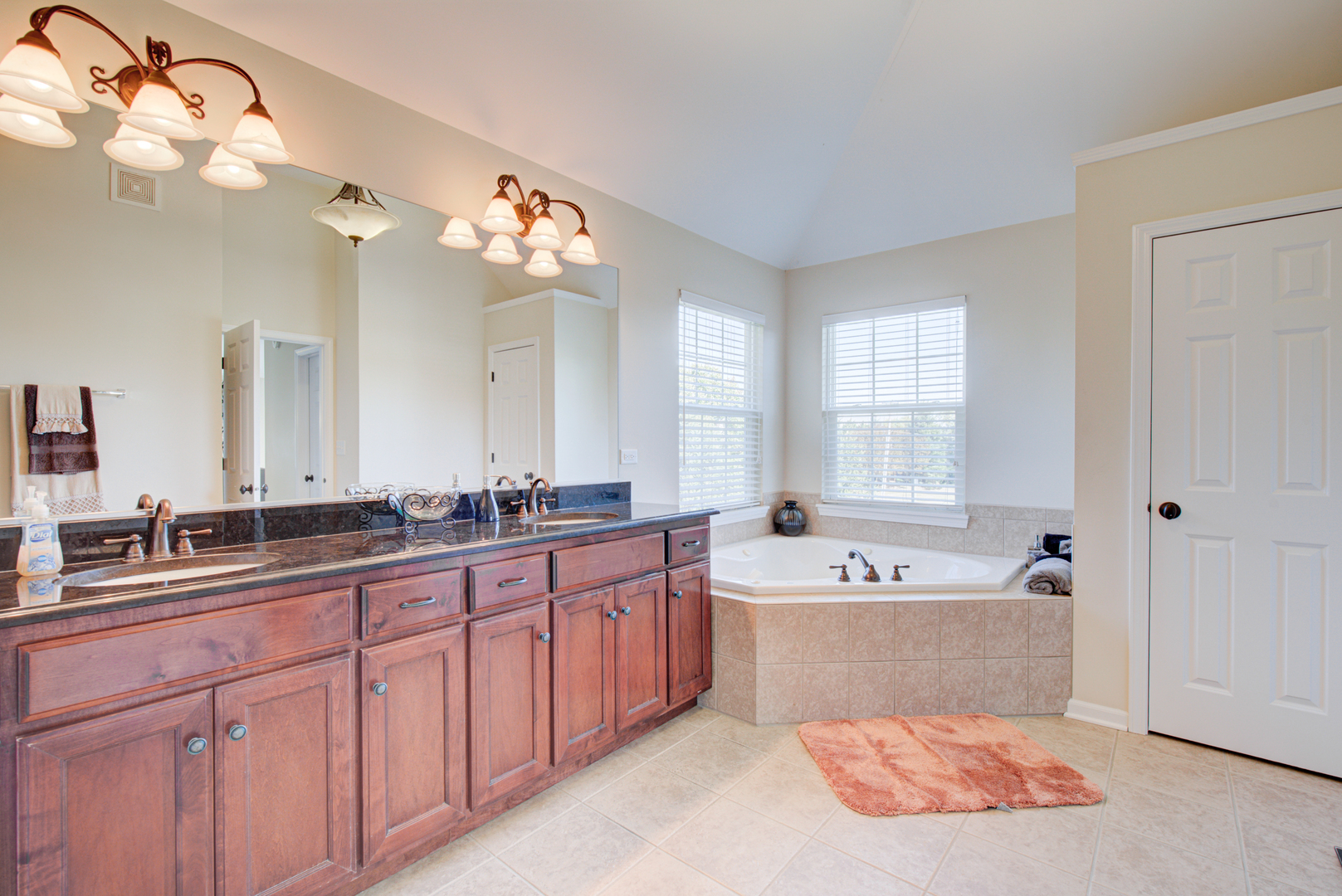 24520 Rockefeller Court Plainfield, IL 60544 - Photo 35 of 57 a bathroom with a tub sink double vanity and a mirror