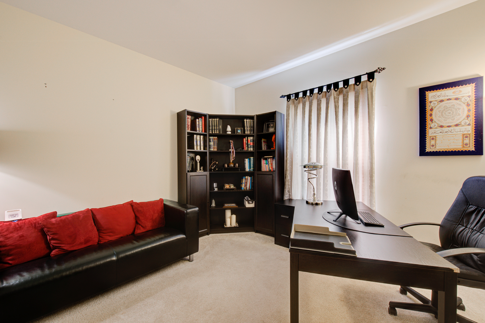 24520 Rockefeller Court Plainfield, IL 60544 - Photo 39 of 57 a living room with a couch and bookshelf