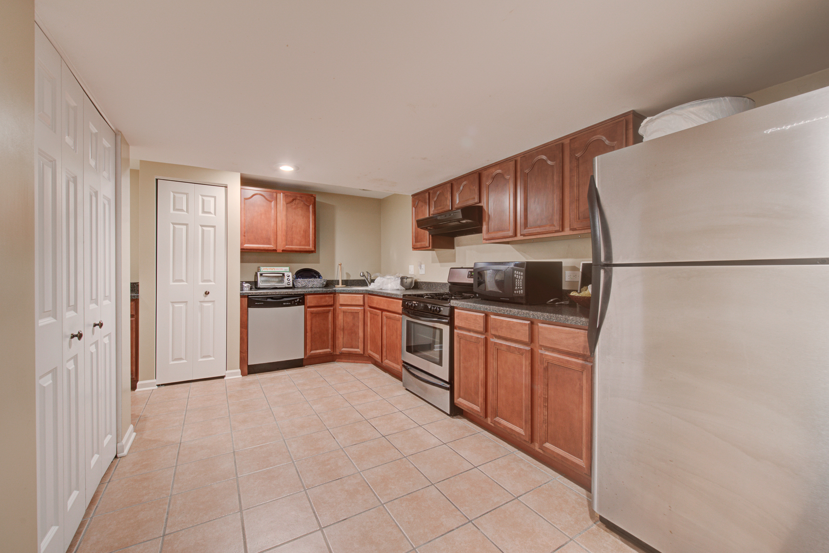 24520 Rockefeller Court Plainfield, IL 60544 - Photo 48 of 57 a kitchen with stainless steel appliances granite countertop a refrigerator sink and cabinets
