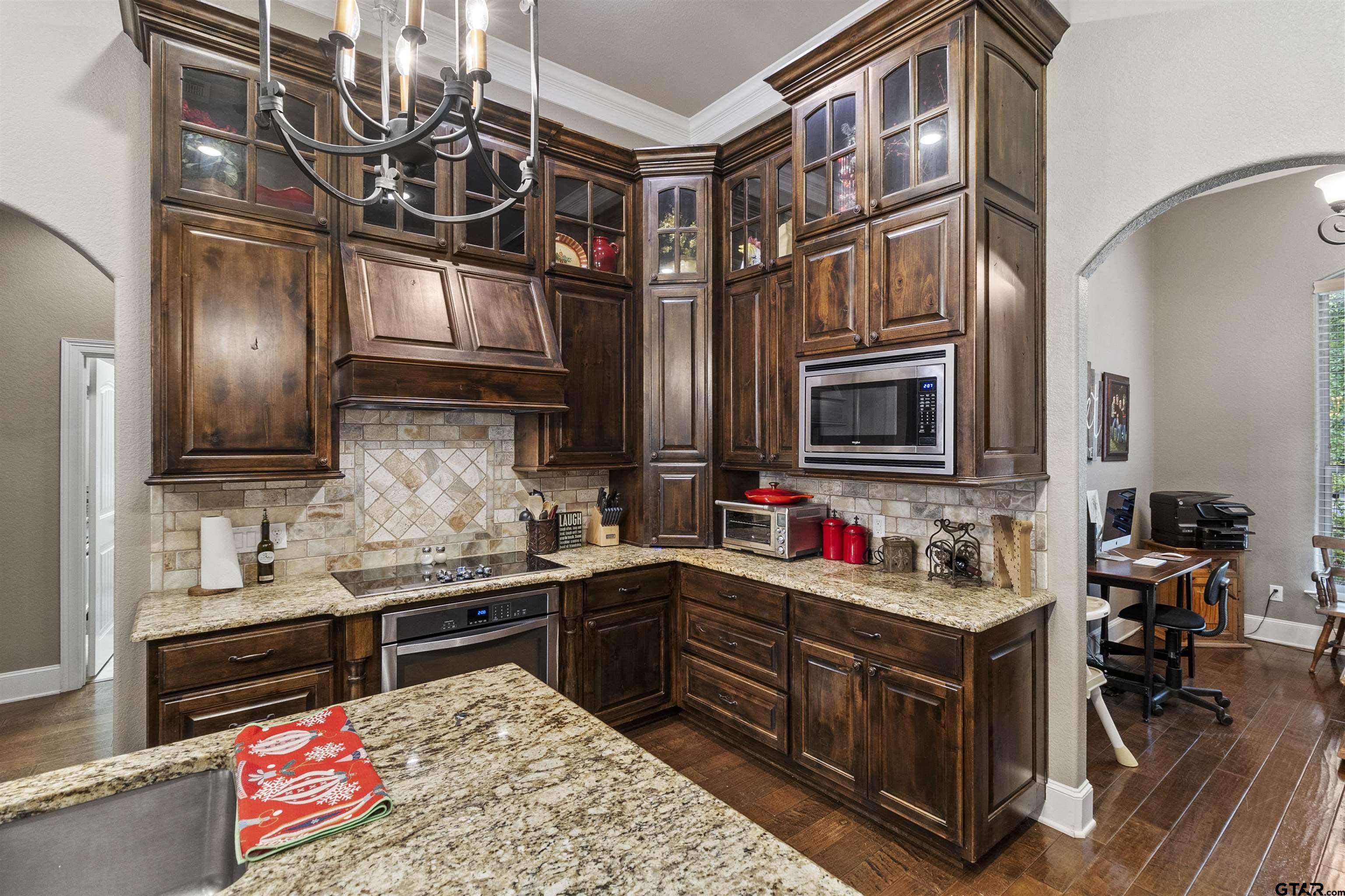 21755 Pagosa Ranch Road Bullard, TX 75757 - Photo 19 of 37 a kitchen that has a lot of cabinets in it