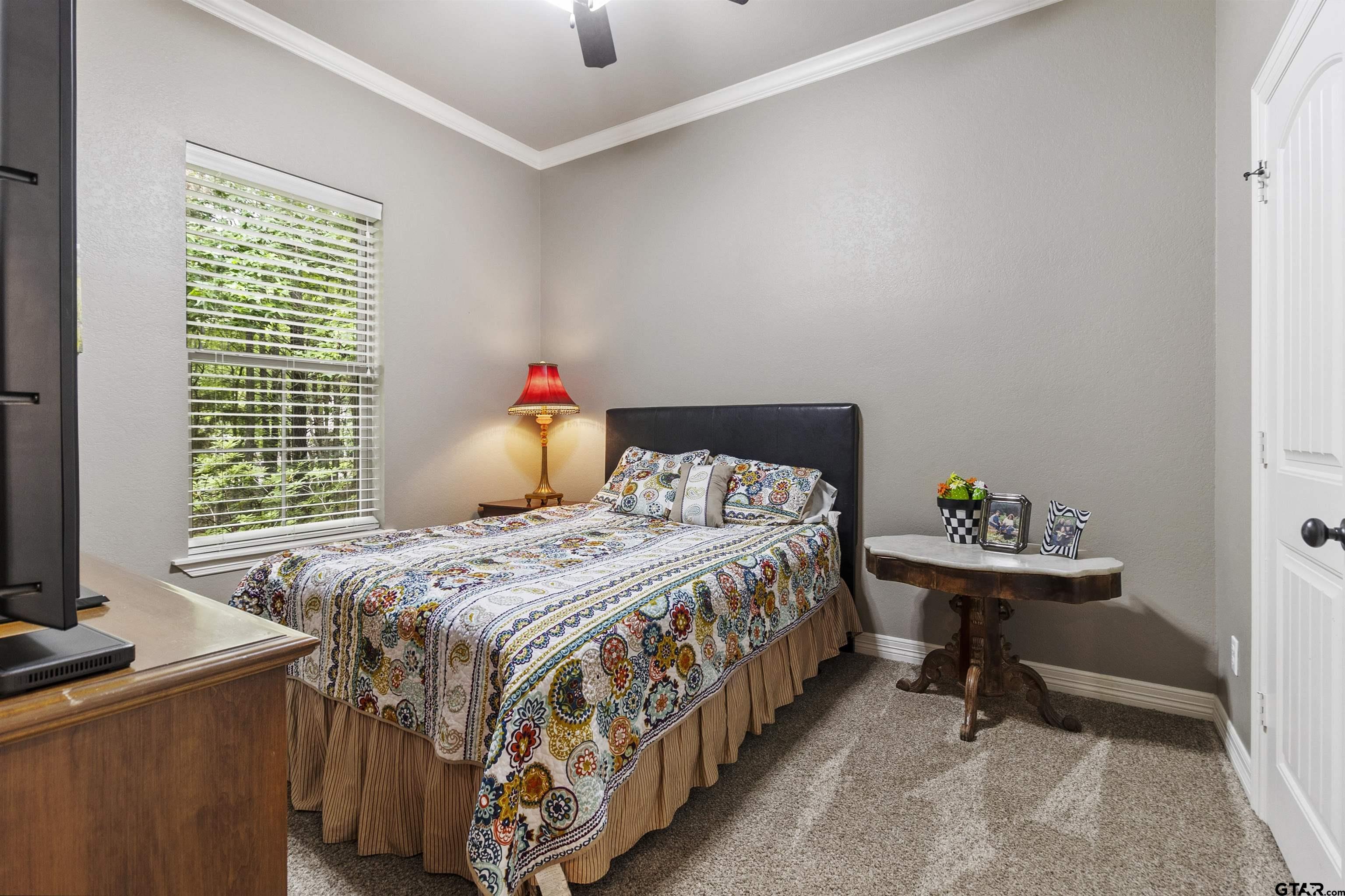 21755 Pagosa Ranch Road Bullard, TX 75757 - Photo 24 of 37 a bedroom with a bed and a table