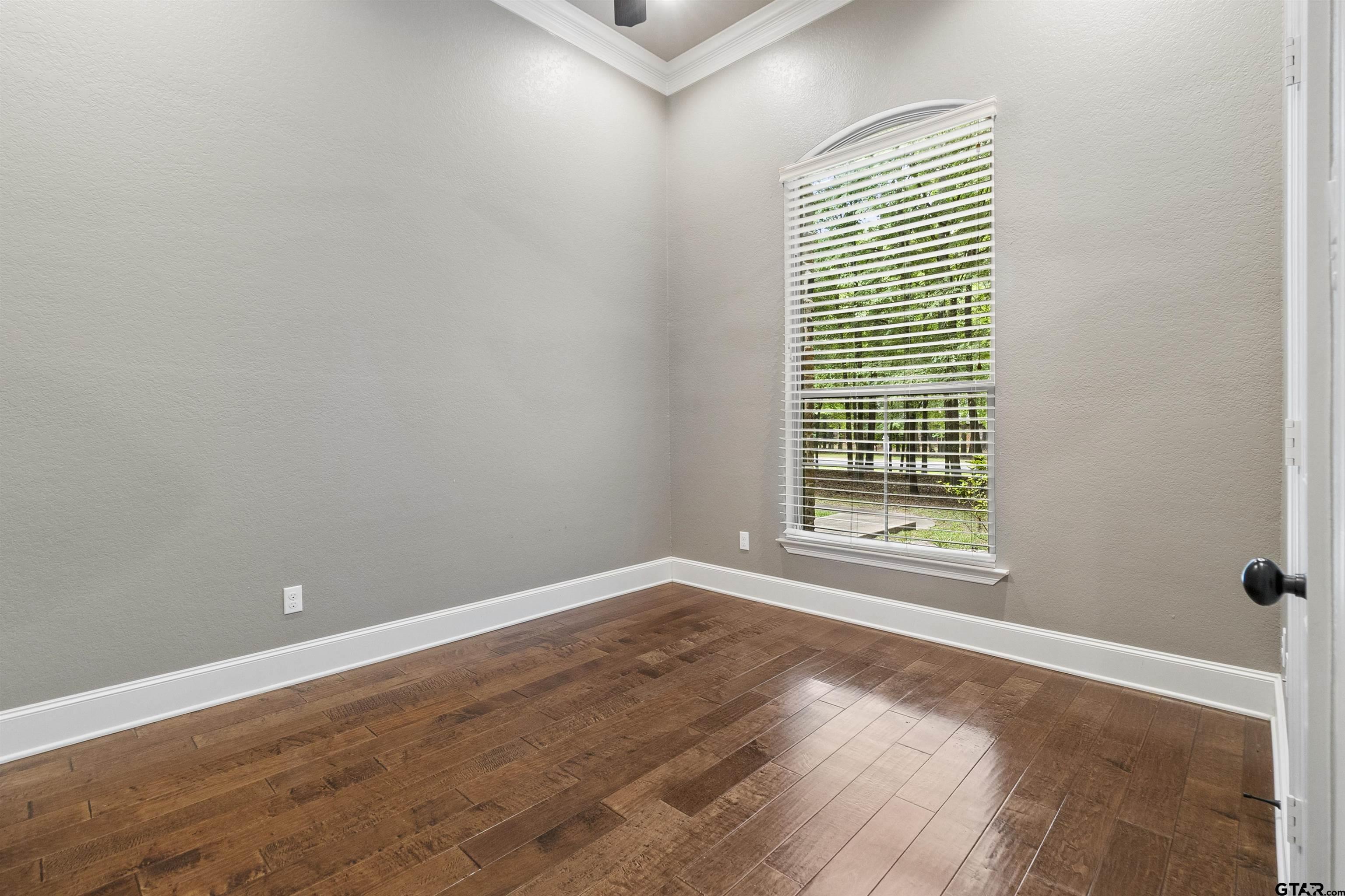 21755 Pagosa Ranch Road Bullard, TX 75757 - Photo 25 of 37 a view of an empty room with wooden floor and a window