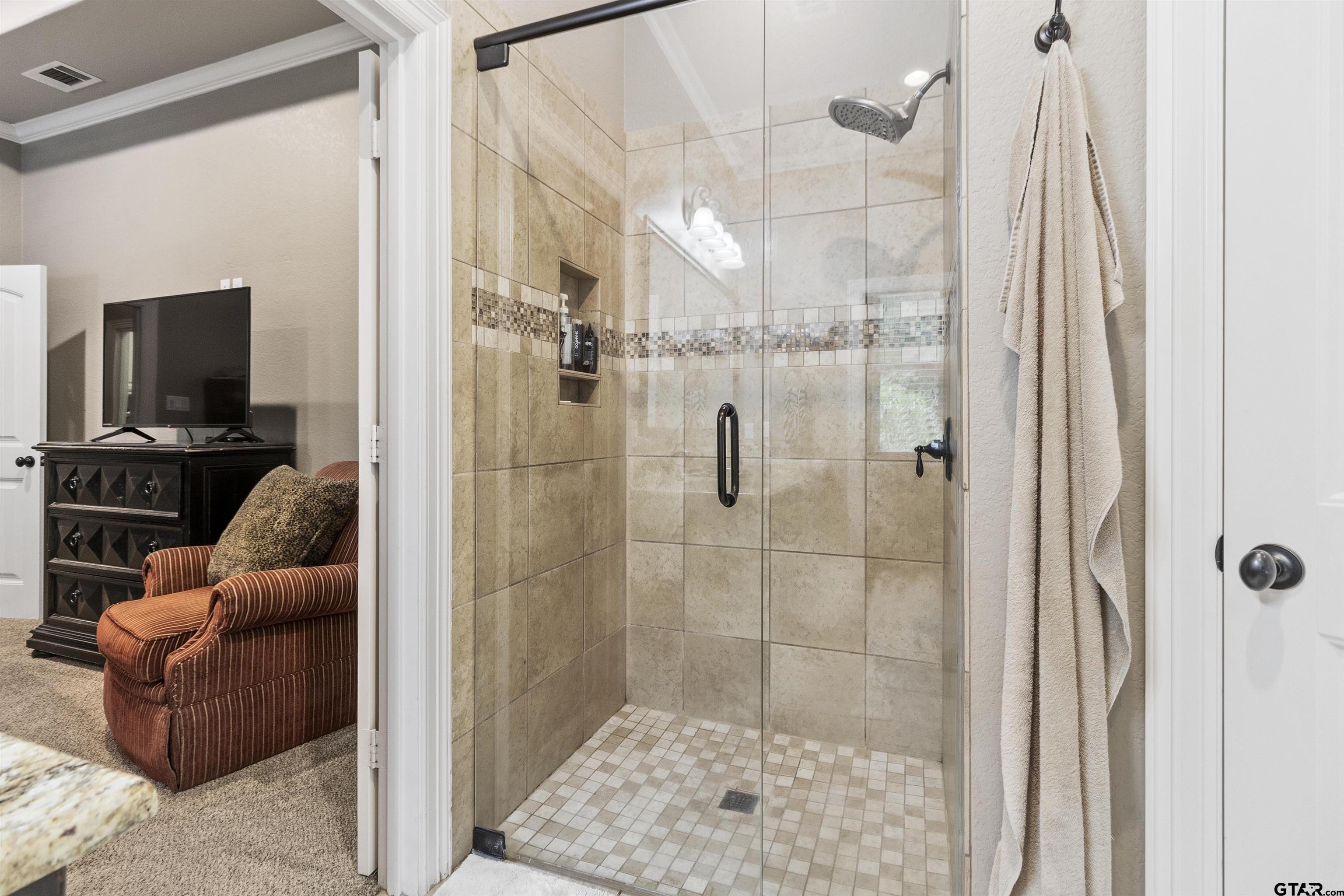 21755 Pagosa Ranch Road Bullard, TX 75757 - Photo 31 of 37 a bathroom with a glass shower door