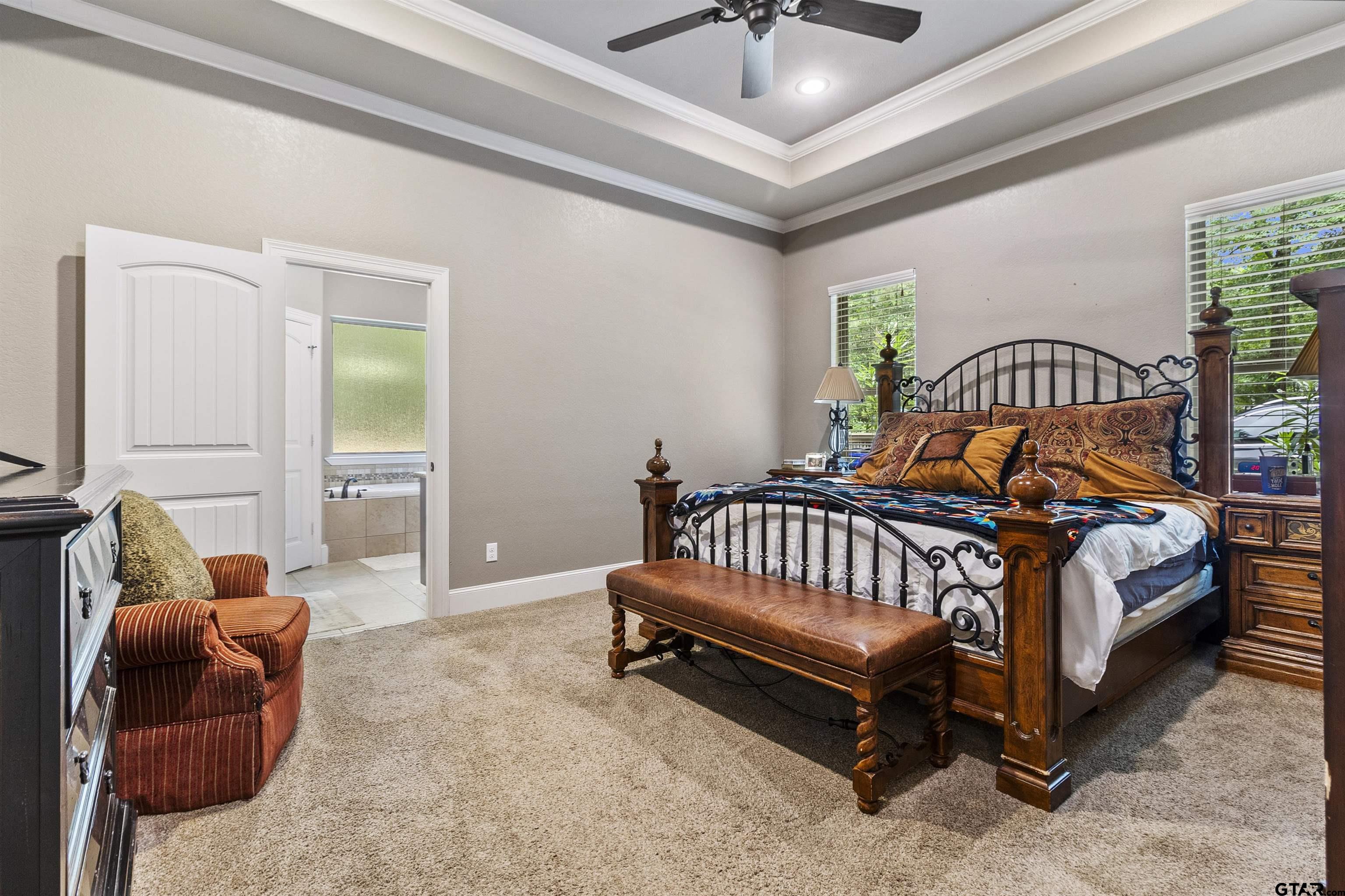 21755 Pagosa Ranch Road Bullard, TX 75757 - Photo 33 of 37 a spacious bedroom with a bed and a couch