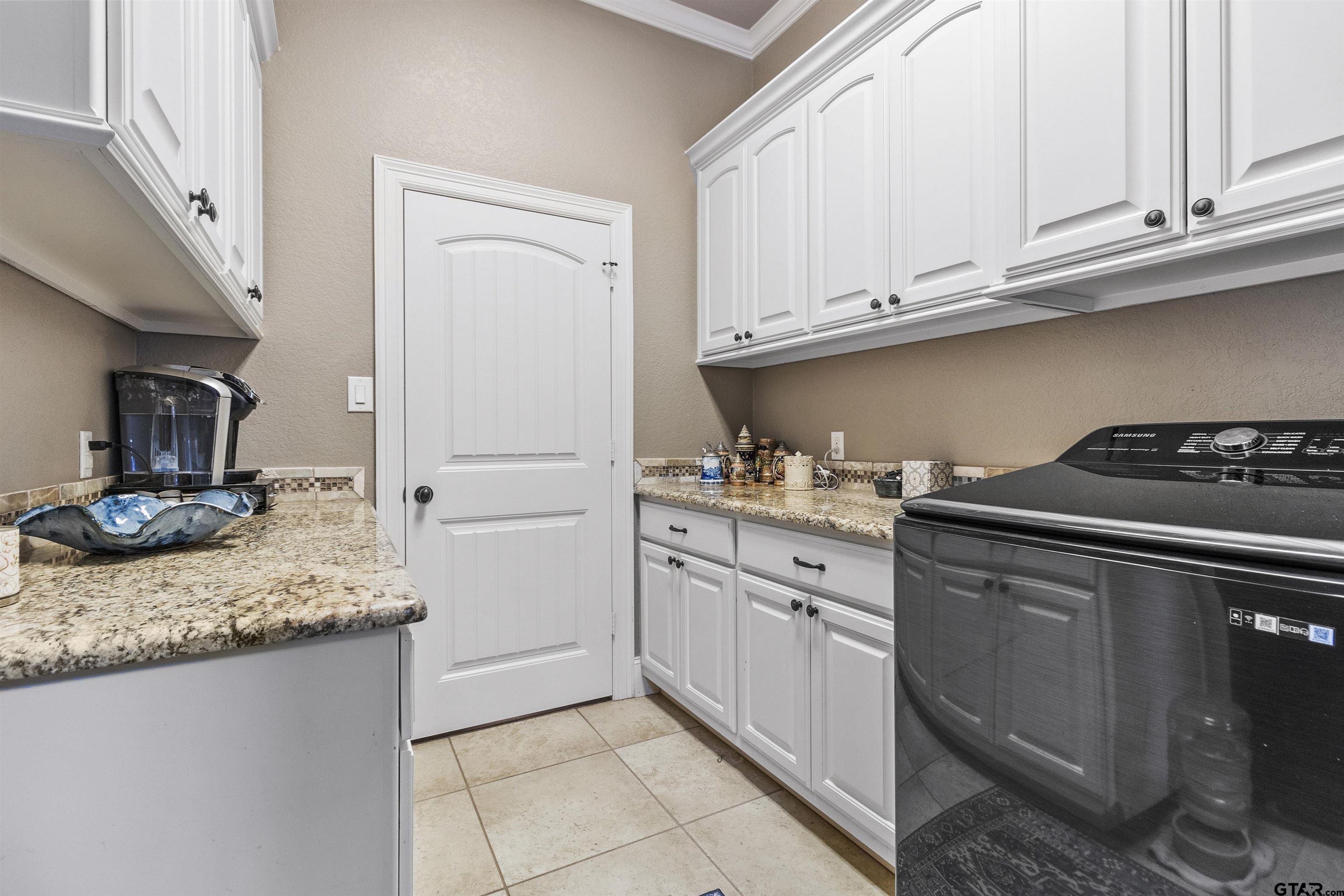 21755 Pagosa Ranch Road Bullard, TX 75757 - Photo 34 of 37 a kitchen with granite countertop cabinets and steel stainless steel appliances