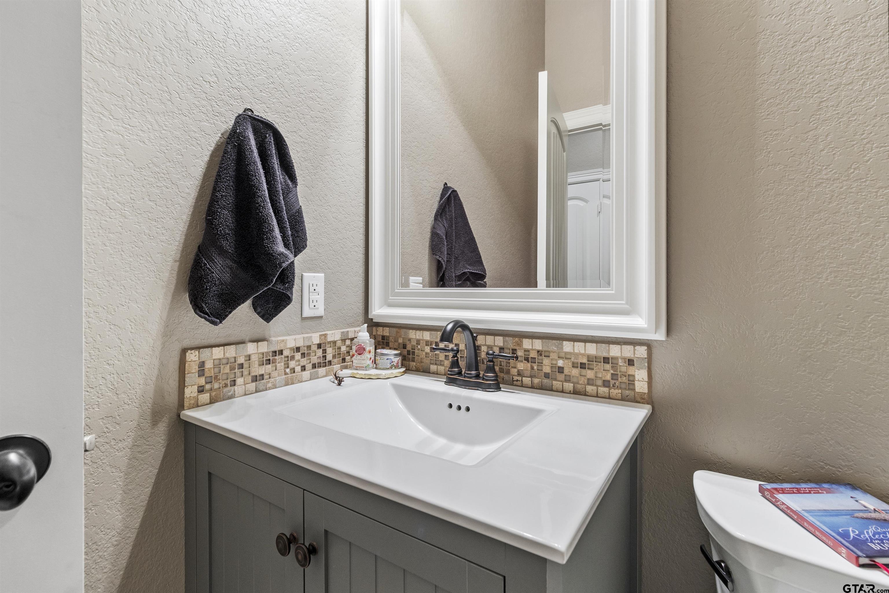 21755 Pagosa Ranch Road Bullard, TX 75757 - Photo 36 of 37 a bathroom with a sink and a toilet