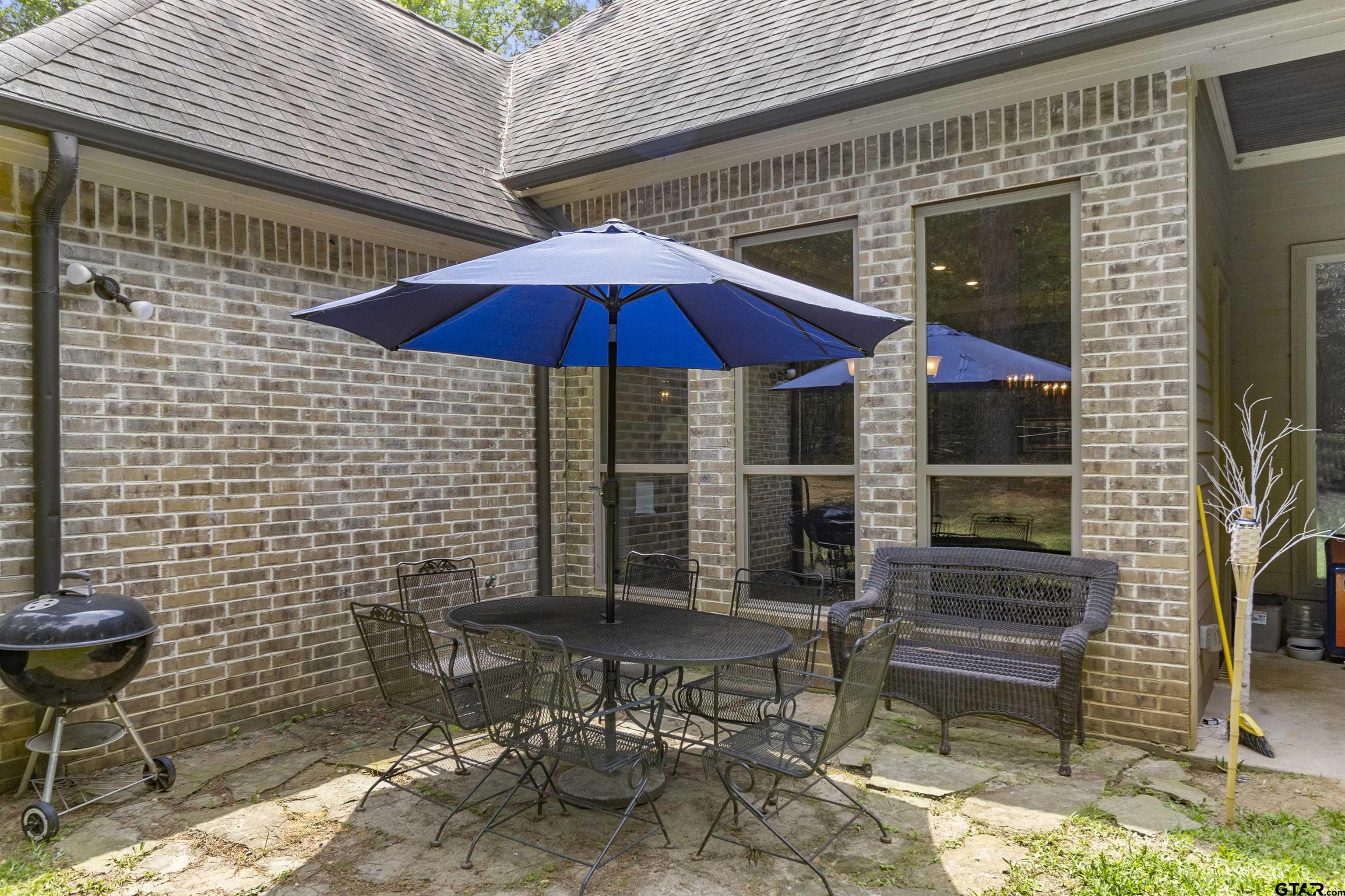 21755 Pagosa Ranch Road Bullard, TX 75757 - Photo 6 of 37 a view of a patio with table and chairs under an umbrella