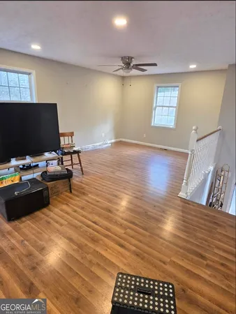 a view of a workspace with furniture and a flat screen tv