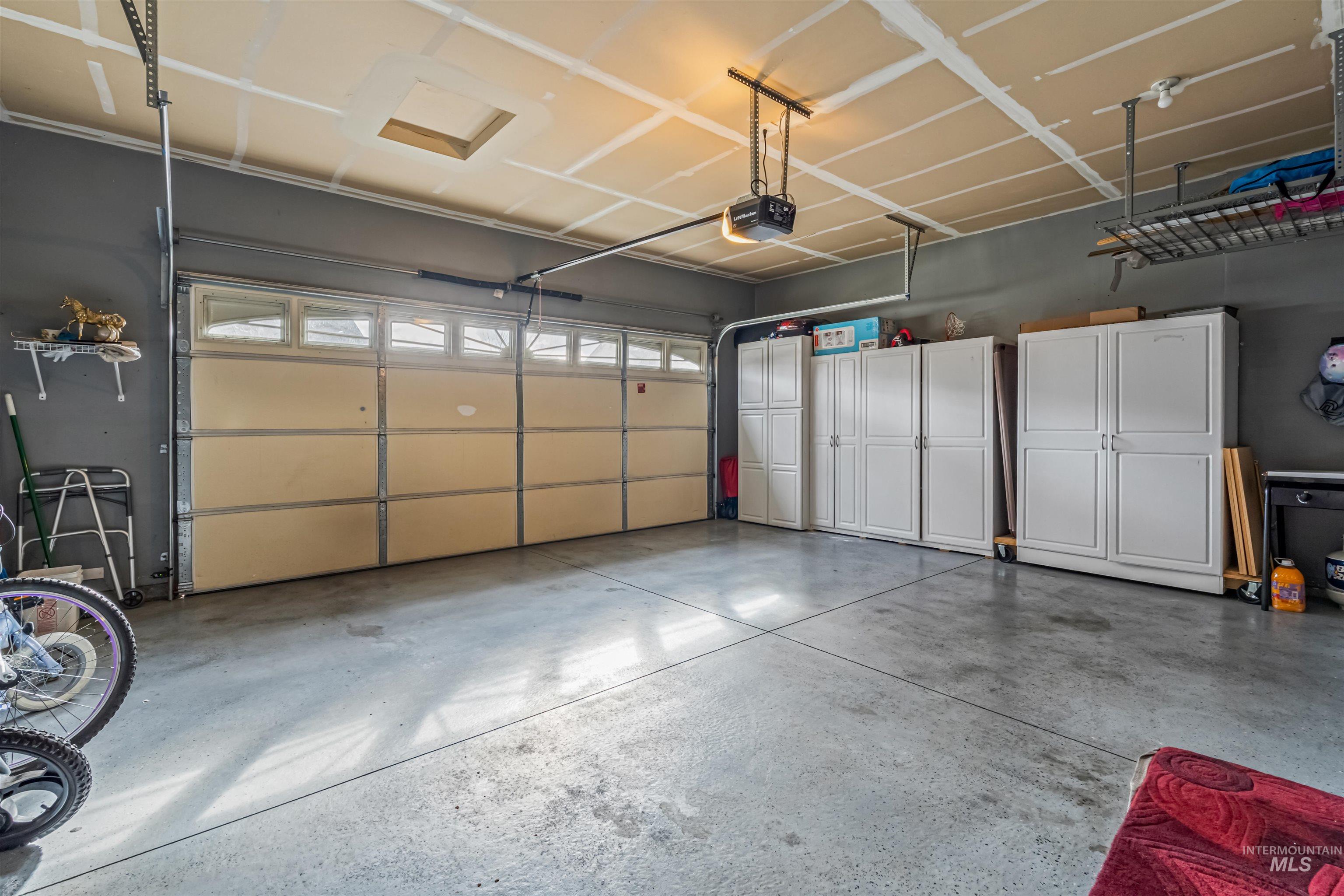 12030 West Abram Street Boise, ID 83713 - Photo 14 of 26 Garage with a garage door opener