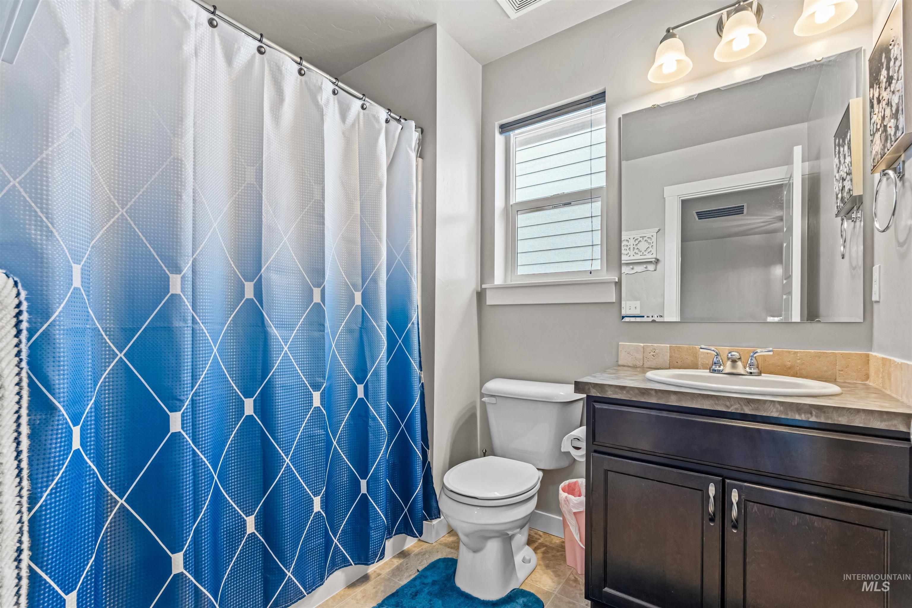 12030 West Abram Street Boise, ID 83713 - Photo 23 of 26 Full bathroom featuring vanity and a shower with shower curtain