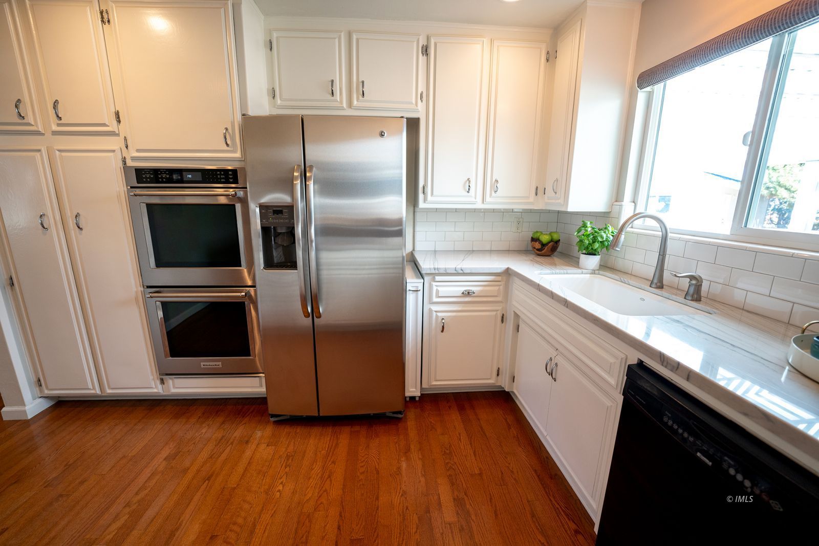 320 Apollo Circle Bishop, CA 93514 - Photo 14 of 35 a kitchen with a refrigerator sink and cabinets