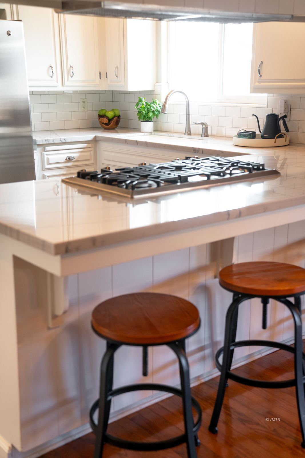 320 Apollo Circle Bishop, CA 93514 - Photo 17 of 35 a kitchen with stainless steel appliances granite countertop a table chairs in it and wooden cabinets