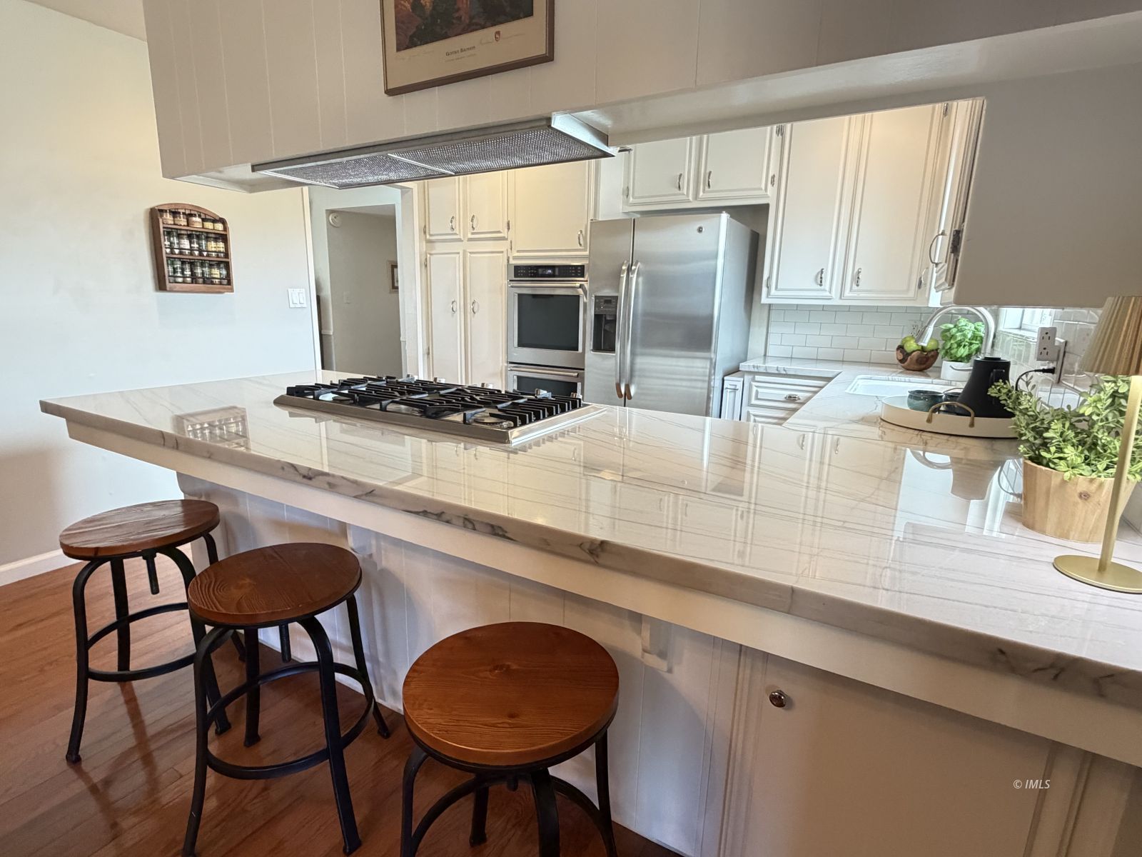 320 Apollo Circle Bishop, CA 93514 - Photo 19 of 35 a kitchen with stainless steel appliances granite countertop a table chairs and a refrigerator