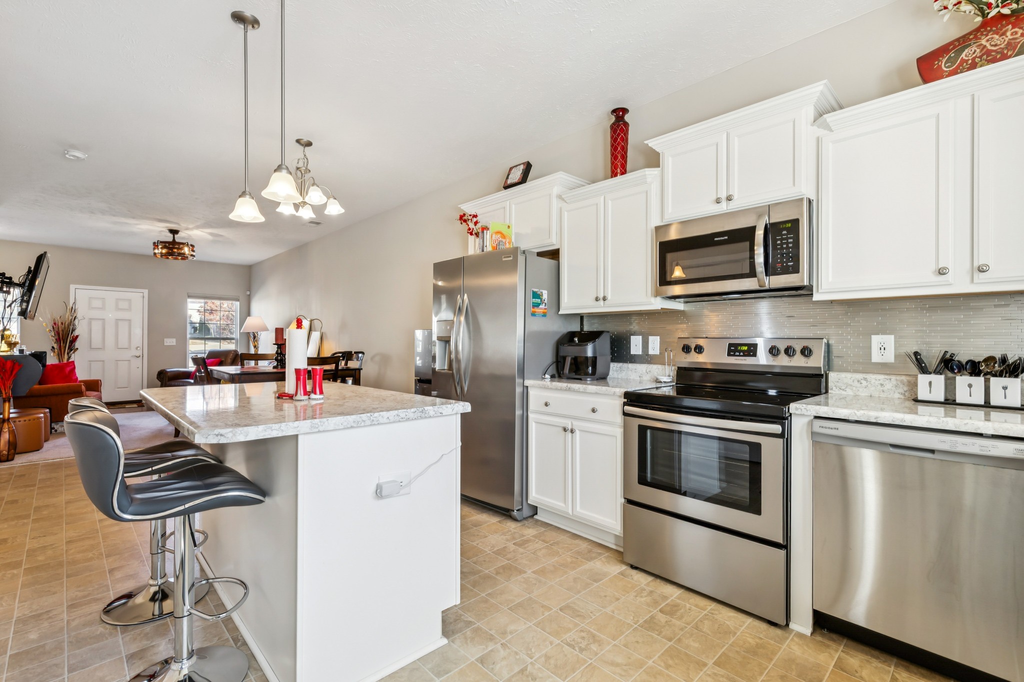 5840 Monroe Crossing Antioch, TN 37013 - Photo 11 of 25 a kitchen that has a lot of white cabinets and stainless steel appliances