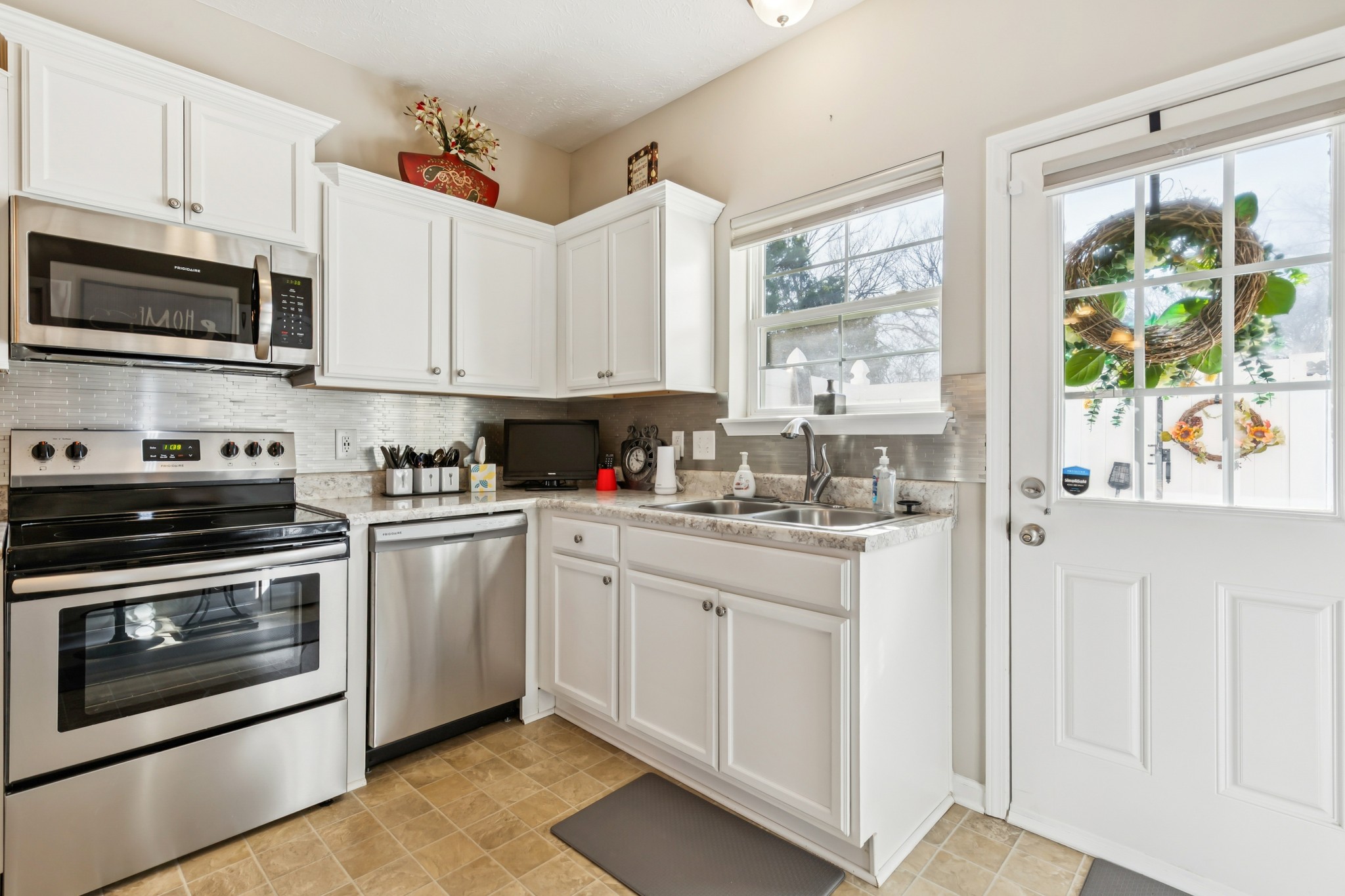 5840 Monroe Crossing Antioch, TN 37013 - Photo 12 of 25 a kitchen with stainless steel appliances white cabinets and a stove top oven