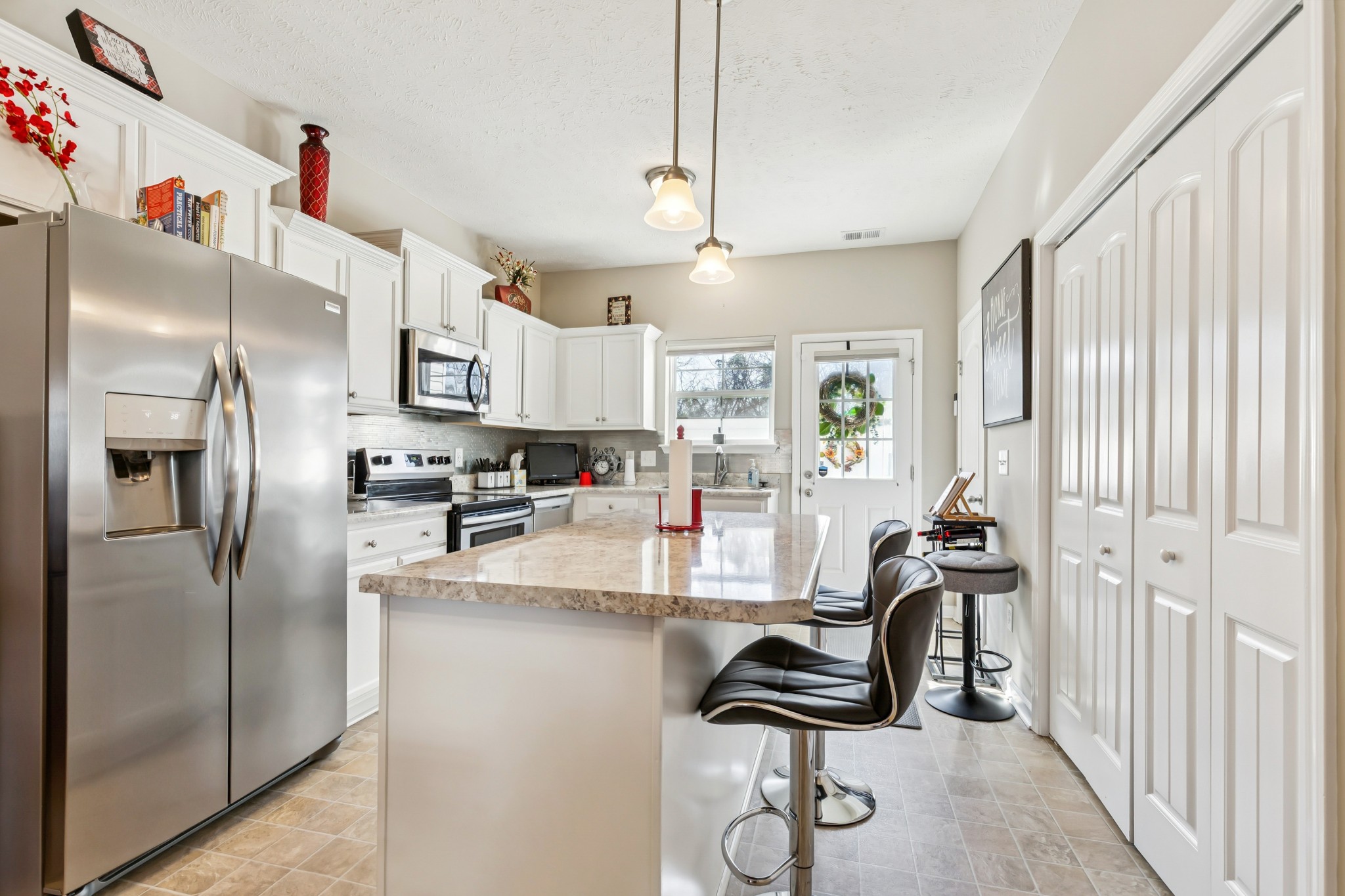 5840 Monroe Crossing Antioch, TN 37013 - Photo 10 of 25 a kitchen with stainless steel appliances kitchen island granite countertop a refrigerator and a sink