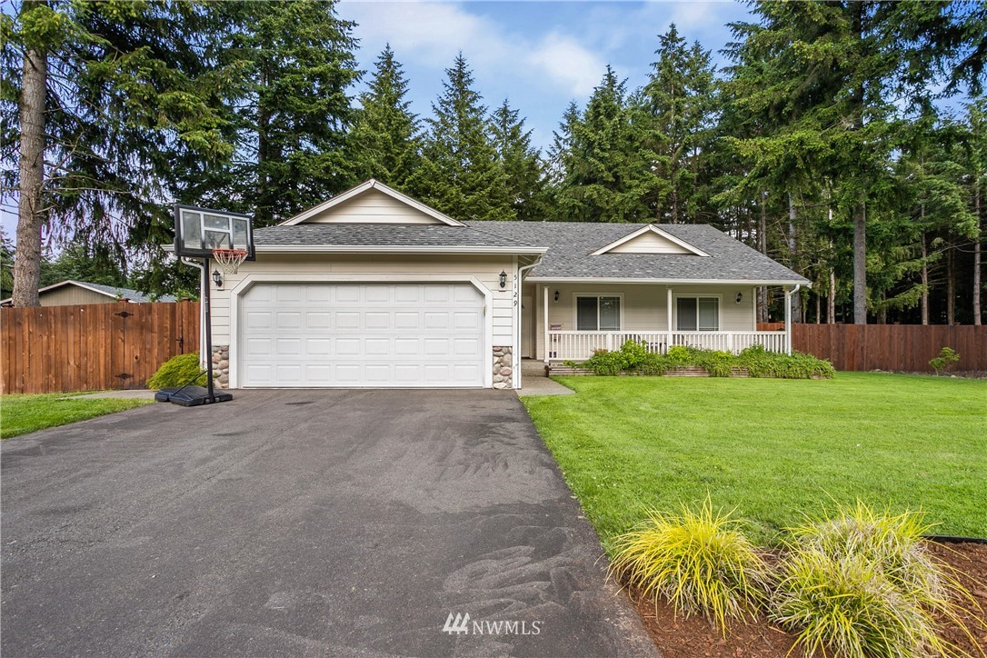 5129 180th Trail Southwest Rochester, WA 98579 - Photo 1 of 22 a front view of a house with a yard and garage